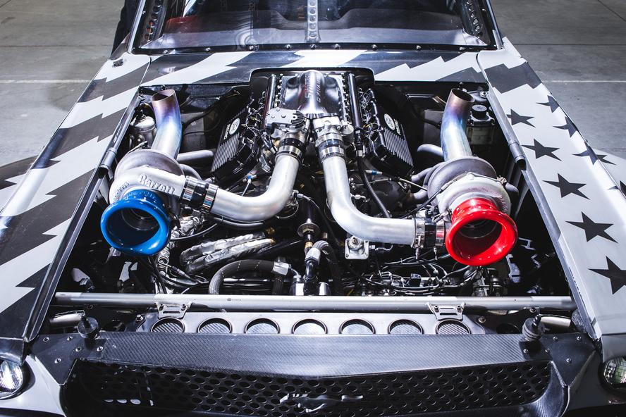Just when you thought that one of the most iconic custom car builds of the last decade couldn’t get any better, Ken Block and Hoonigan have gone and improved upon the perfection that was Block’s 1965 Ford Mustang Hoonicorn RTR from Gymkhana SEVEN. How you ask? By adding two turbos to the equation and adding methanol.